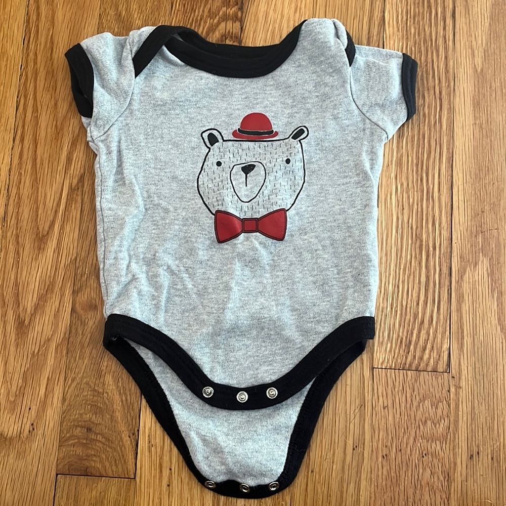 Bear in bowler hat and bow tie onesie